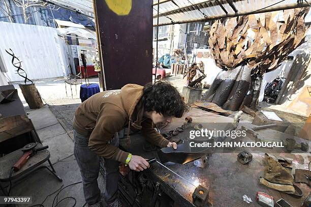 Italian artist Zazzaro works on a metal sculpture at the Kunsthaus Tacheles artists' colony's outdoor gallery in Berlin's mitte district March 22,...
