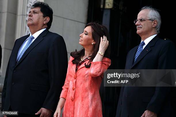 Argentina's President Cristina Fernandez de Kirchner , her Foreign Minister Jorge Taiana and Peruvian President Alan Garcia stand during a ceremony...
