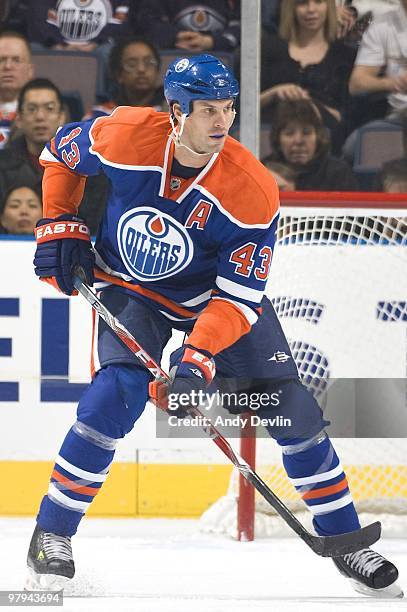 Jason Strudwick of the Edmonton Oilers defends the zone against the San Jose Sharks at Rexall Place on March 21, 2010 in Edmonton, Alberta, Canada....