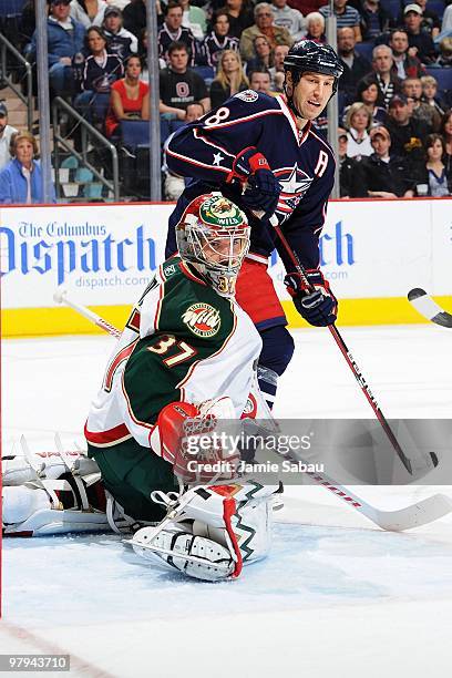 Goaltender Josh Harding of the Minnesota Wild defends the net as forward R.J. Umberger of the Columbus Blue Jackets looks for the puck on March 19,...