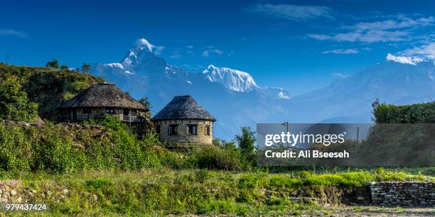 stone building and himalayas in background, pokhara, kaski, nepal - pokhara stock pictures, royalty-free photos & images