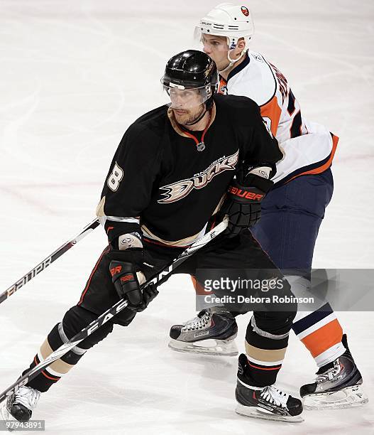 Teemu Selanne of the Anaheim Ducks defends against Sean Bergenheim of the New York Islanders during the game on March 19, 2010 at Honda Center in...