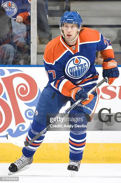 Tom Gilbert of the Edmonton Oilers follows the play against the San Jose Sharks at Rexall Place on March 21, 2010 in Edmonton, Alberta, Canada. The...