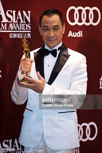 Chinese actor Wang Xueqi poses backstage after winning the Best Actor Award during the 4th Asian Film Awards ceremony at the Convention and...