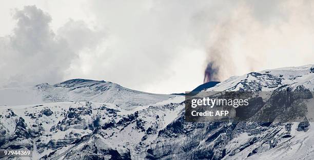 Smoke rises and lava spews from the site of a volcanic eruption behind the Eyjafjallajoekull glacier, some125 kilometres east of Iceland's capital...