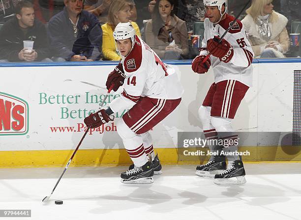 Ed Jovanovski looks on as Taylor Pyatt of the Phoenix Coyotes skates with the puck against the Florida Panthers on March 18, 2010 at the BankAtlantic...