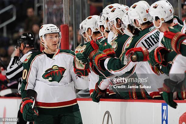 Forward Antti Miettinen of the Minnesota Wild is congratulated by his teammates after assisting on a goal against the Columbus Blue Jackets on March...