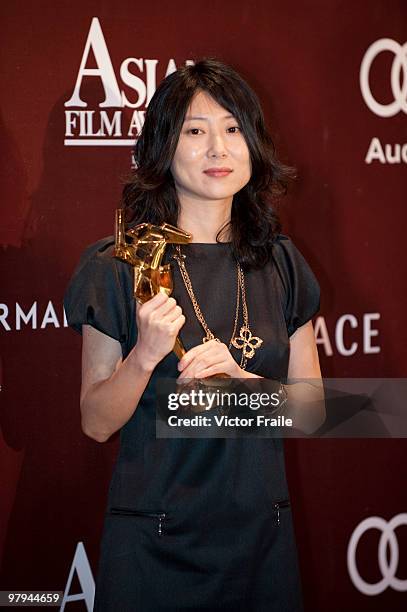 South Korea's Park Eun-kyo poses backstage after winning the Best Screenwriter Award during the 4th Asian Film Awards ceremony at the Convention and...