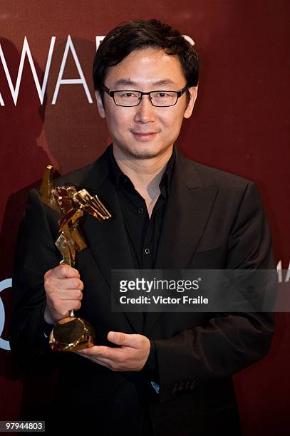 Chinese director Lu Chuan poses backstage after winning the Best Director award for his movie "City of Life and Death" during the 4th Asian Film...
