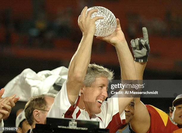 Head Coach Pete Carroll holds up the National Championship Trophy during the FedEx Orange Bowl National Championship at Pro Player Stadium in Miami,...