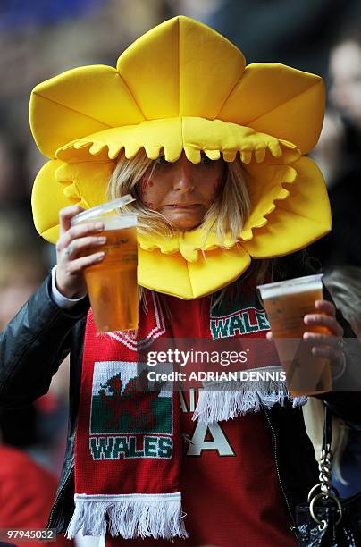 Welsh fan struggles with her beers while getting to her seat ahead of the Wales versus Italy RBS Six Nations International rugby union match at the...