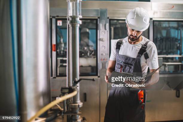 the worker controls the operation of the machine - obradovic stock pictures, royalty-free photos & images