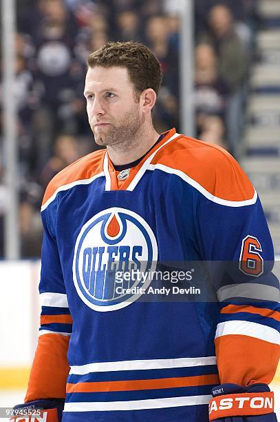 Ryan Whitney of the Edmonton Oilers stands for the national anthems before a game against the San Jose Sharks at Rexall Place on March 21, 2010 in...