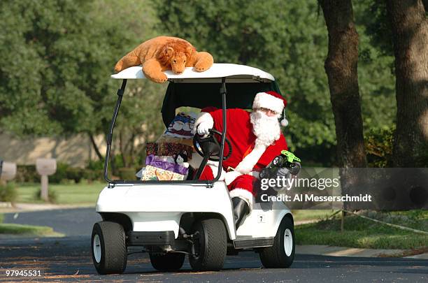 Santa trades his sleigh for a golf cart to deliver Christmas presents.
