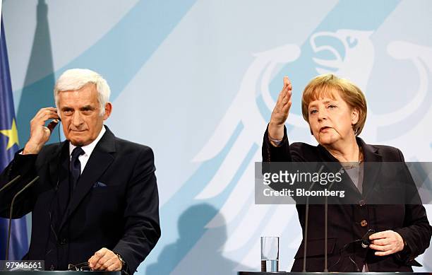 Jerzy Buzek, president of the European Parliament, left and Angela Merkel, Germany's chancellor, hold a news conference in Berlin, Germany, on...