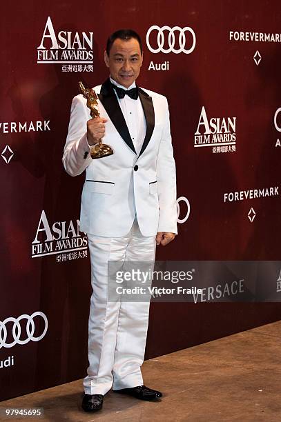 Chinese actor Wang Xueqi poses backstage after winning the Best Actor Award during the 4th Asian Film Awards ceremony at the Convention and...