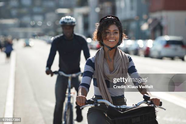 couple using rental bikes in the small town sausalito - bicycle rental stockfoto's en -beelden