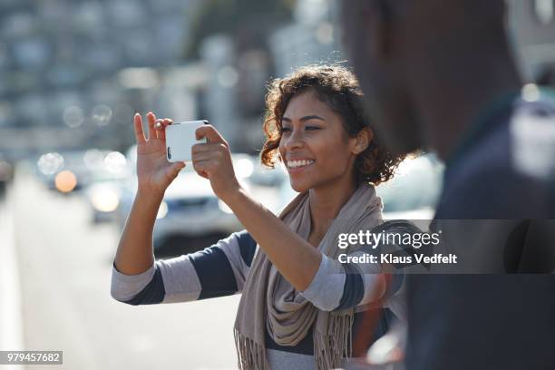 woman taking tourist photo with smartphone - take pictures stock-fotos und bilder