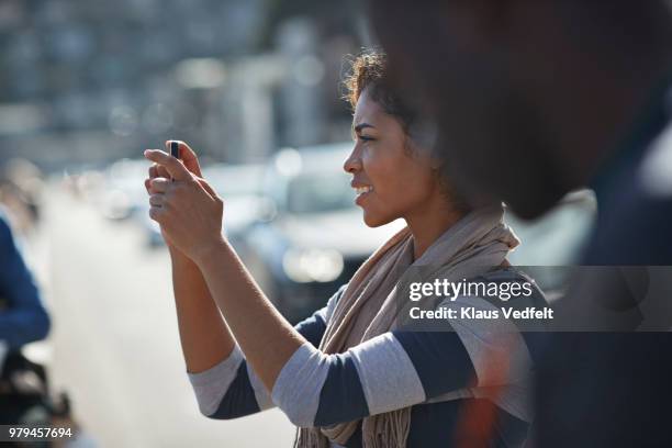 woman taking tourist photo with smartphone - profile shoot of actor aradhya taing stockfoto's en -beelden