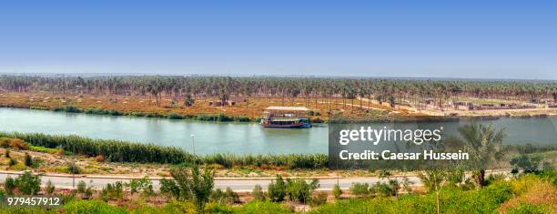 landscape with river and plains under clear sky, iraq - euphrates river stock-fotos und bilder