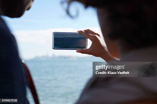 couple making tourist photo with smartphone - taking photo with phone stock pictures, royalty-free photos & images