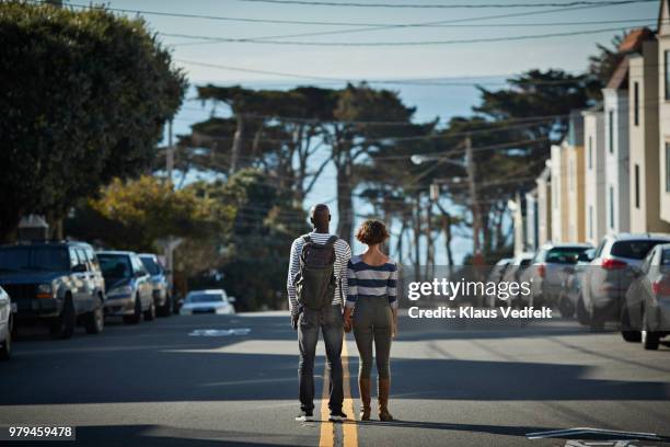 couple walking the steep hills of san francisco - two cars side by side stock pictures, royalty-free photos & images