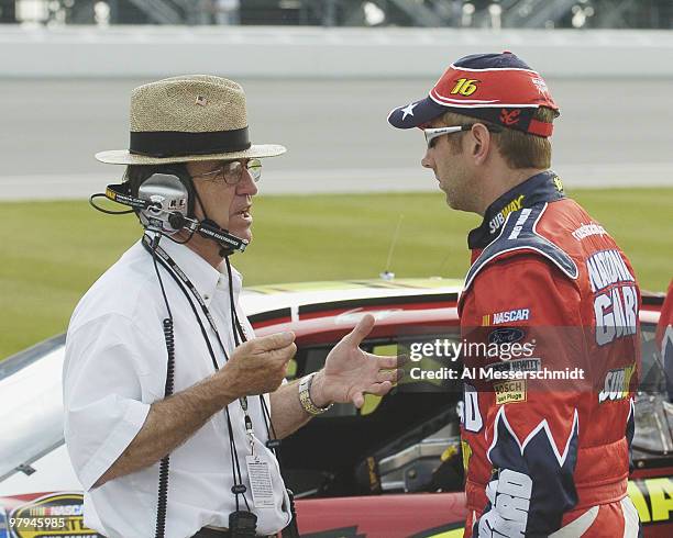 Car owner Jack Roush talks with driver Greg Biffle during qualifying for the NASCAR Nextel Cup Tropicana 400 at Chicagoland Speedway, July 9, 2004.