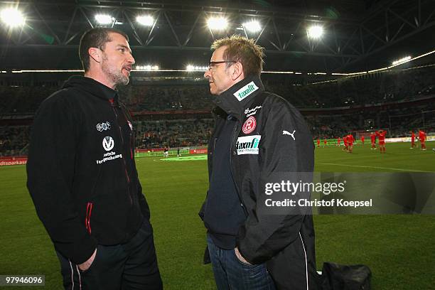 Head coach Marco Kurz of Kaiserslautern and Head coach Norbert Meier of Duesseldorf talk before the Second Bundesliga match between Fortuna...