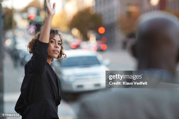 businesswoman hailing cab on the streets of san francisco - hail foto e immagini stock