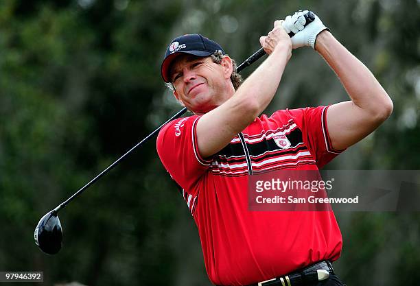 Lee Janzen plays a shot on the 3rd hole during the first day's play in the 2010 Tavistock Cup at Isleworth Golf and Country Club on March 22, 2010 in...