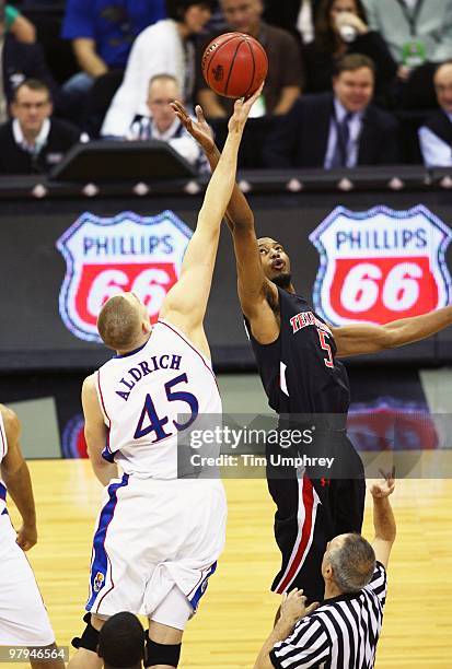 Cole Aldrich of the Kansas Jayhawks goes up for the tipoff against D'walyn Roberts of the Texas Tech Red Raiders during the quarterfinals of the 2010...