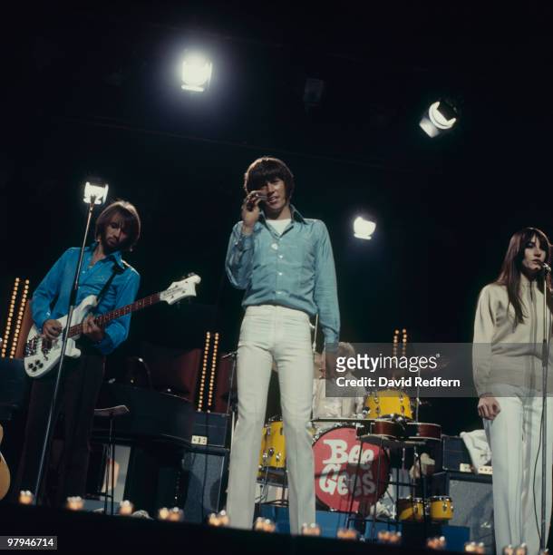 Maurice Gibb and Barry Gibb of the Bee Gees perform on stage with sister Lesley in 1969.