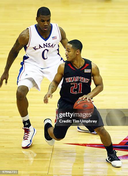 John Roberson of the Texas Tech Red Raiders tries to elude Thomas Robinson of the Kansas Jayhawks during the quarterfinals of the 2010 Phillips 66...