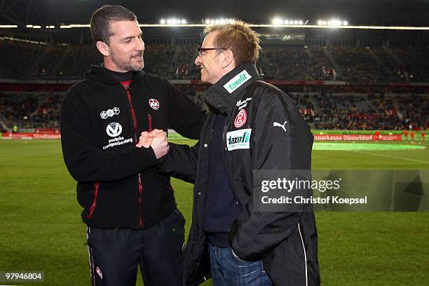 Head coach Marco Kurz of Kaiserslautern and Head coach Norbert Meier of Duesseldorf shake hands before the Second Bundesliga match between Fortuna...