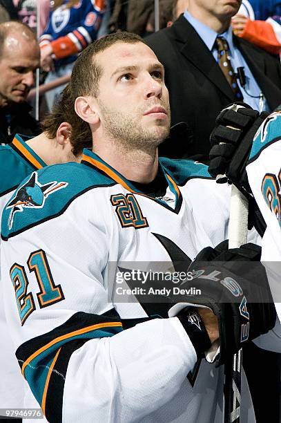 Scott Nichol of the San Jose Sharks stands for the national anthems before a game against the Edmonton Oilers at Rexall Place on March 21, 2010 in...