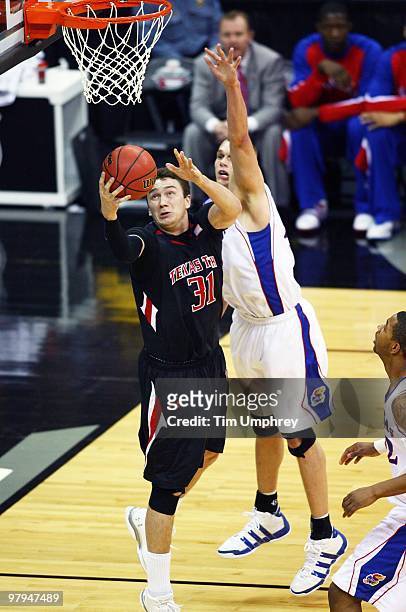 Darko Cohadarevic of the Texas Tech Red Raiders goes up for a reverse layup while defended by Cole Aldrich of the Kansas Jayhawks during the...