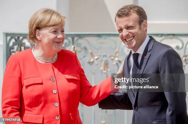 June 2018, Germany, Meseberg: German Chancellor from the Christian Democratic Union , Angela Merkel, standing next to the French President, Emmanuel...