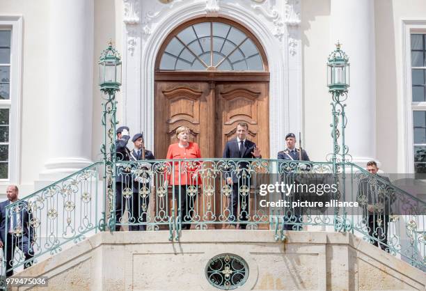 June 2018, Germany, Meseberg: German Chancellor from the Christian Democratic Union , Angela Merkel, standing next to the French President, Emmanuel...