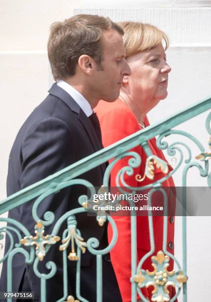 June 2018, Germany, Meseberg: German Chancellor from the Christian Democratic Union , Angela Merkel, standing next to the French President, Emmanuel...