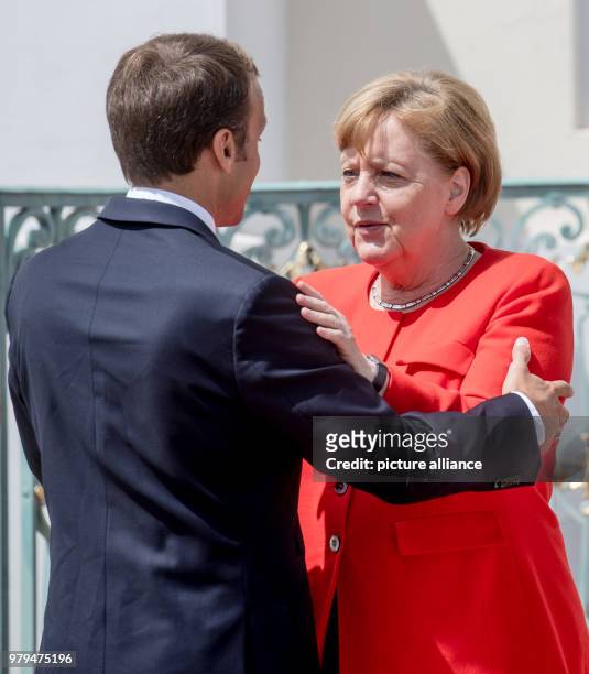 June 2018, Germany, Meseberg: German Chancellor from the Christian Democratic Union , Angela Merkel, standing next to the French President, Emmanuel...