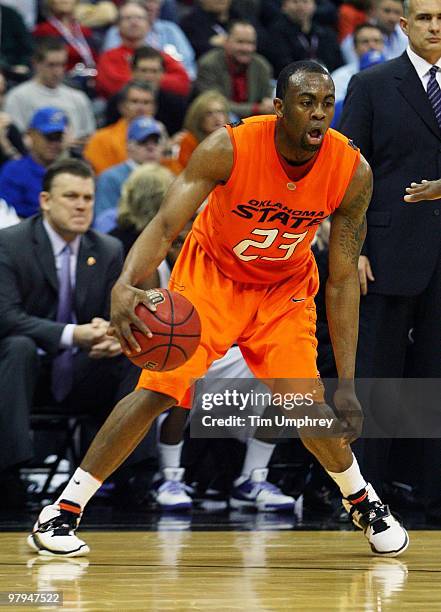 James Anderson of the Oklahoma State Cowboys tries to dribble around the defense of the Kansas State Wildcats during the quarterfinals of the 2010...