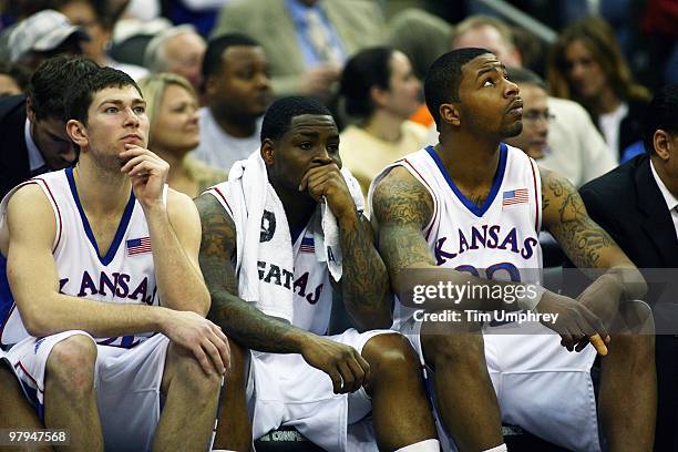 Tyrel Reed, Sherron Collins and Marcus Morris of the Kansas Jayhawks sit on the bench in the closing minutes of a victory over the Texas Tech Red...