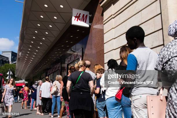 The first customers queue during the opening of the Swedish brand H&M La Fayette flagship store on June 20, 2018 in Paris, France. This sales space...