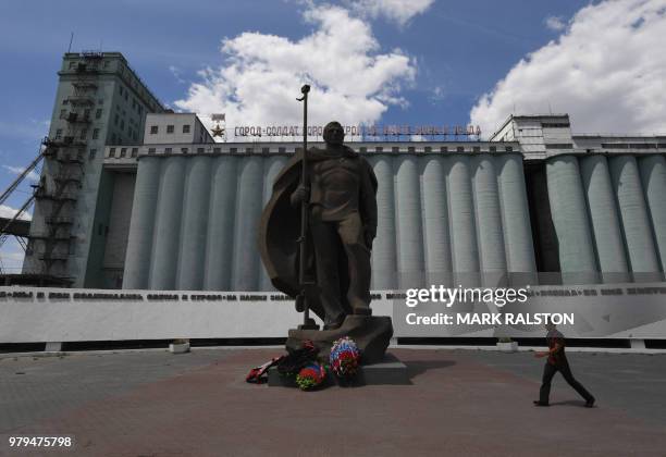 Statue of a Russian soldier is pictured in front of the Grain Elevator which was the scene of heavy fighting during World War II in Volgograd on June...