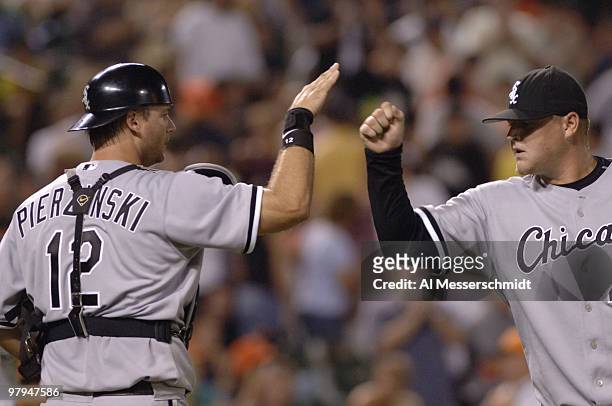 Chicago White Sox relief pitcher Bobby Jenks celebrates with catcher A. J. Pierzynski after the game-ending out against the Baltimore Orioles July...