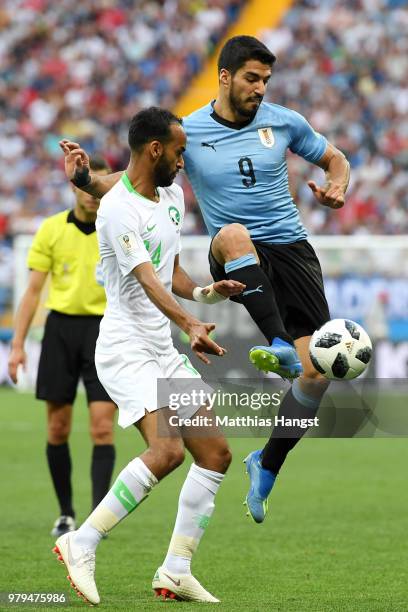 Luis Suarez of Uruguay controls the ball infront of Abdullah Otayf of Saudi Arabia during the 2018 FIFA World Cup Russia group A match between...