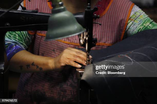 Worker sews pieces of leather at the Dehner Co. Boot factory in Omaha, Nebraska, U.S., on Tuesday, June 5, 2018. Markit is scheduled to release...