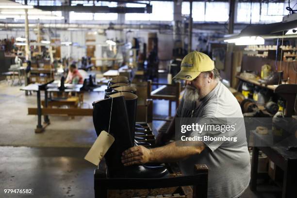 Worker places boots on a shelf at the Dehner Co. Factory in Omaha, Nebraska, U.S., on Tuesday, June 5, 2018. Markit is scheduled to release...