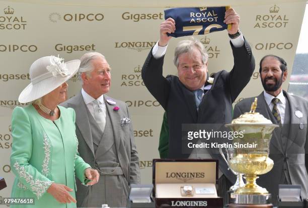 Camilla, Duchess of Cornwall and Prince Charles, Prince of Wales present trainer Sir Michael Stoute and owner Saeed Suhail with the winning trophy...