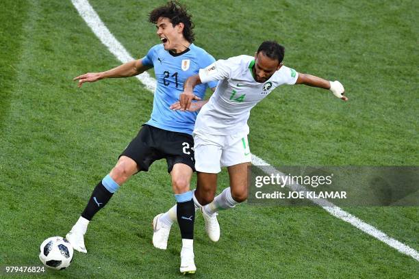 Uruguay's forward Edinson Cavani fights for the ball with Saudi Arabia's midfielder Abdullah Otayf during the Russia 2018 World Cup Group A football...